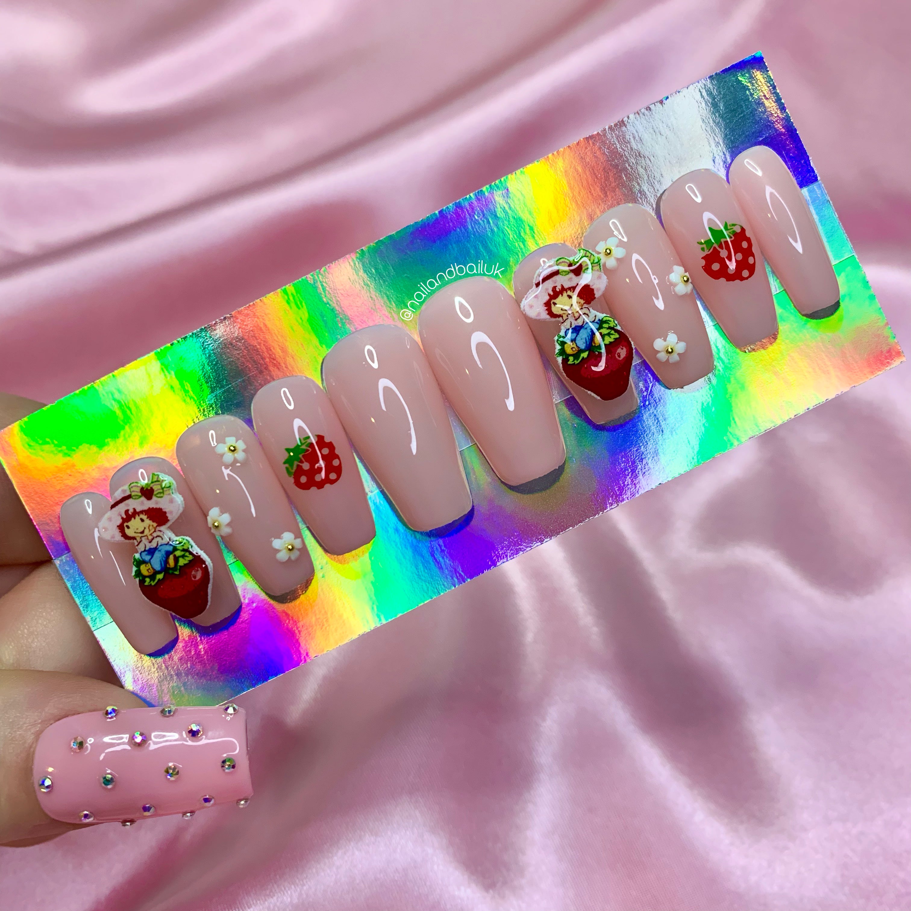 Strawberry Shortcake-inspired charm nail art on cute pastel press-on nails