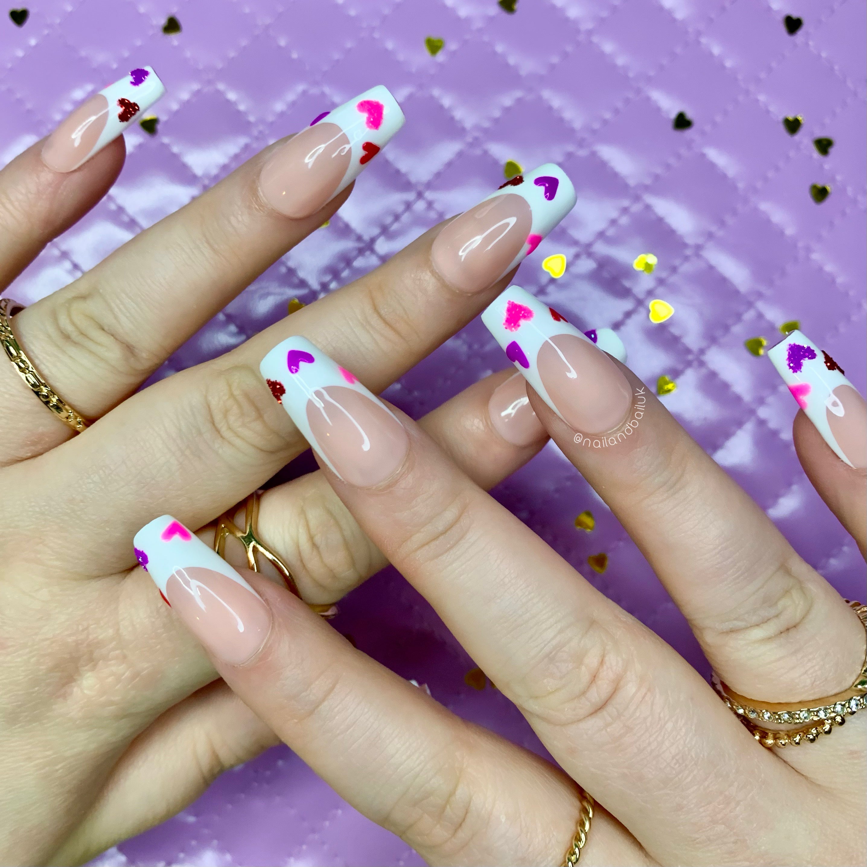 Nude French tip press-on nails with colourful love hearts and sugared glitter details